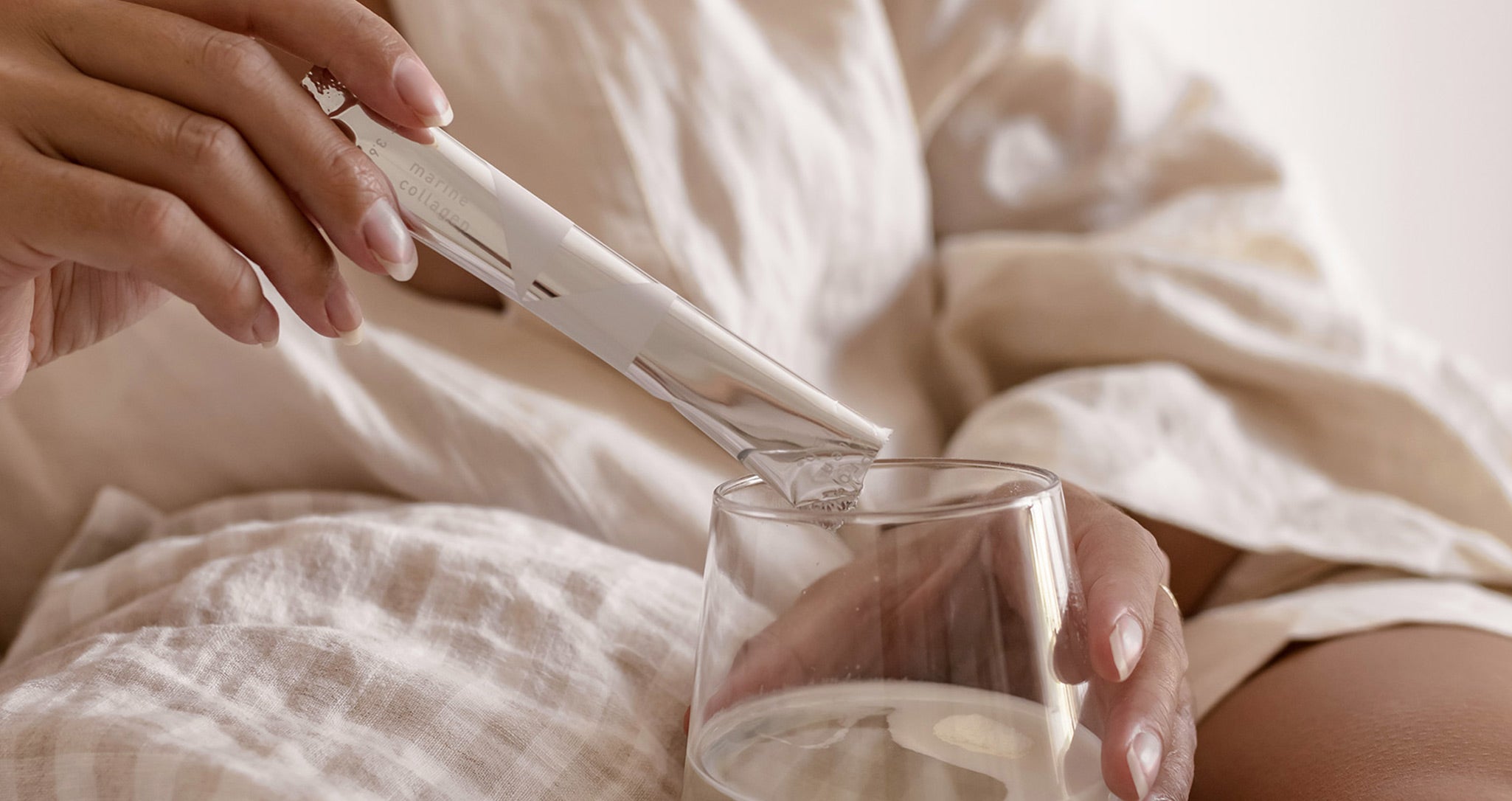 Woman pouring ProPlenish Marine Collagen into glass