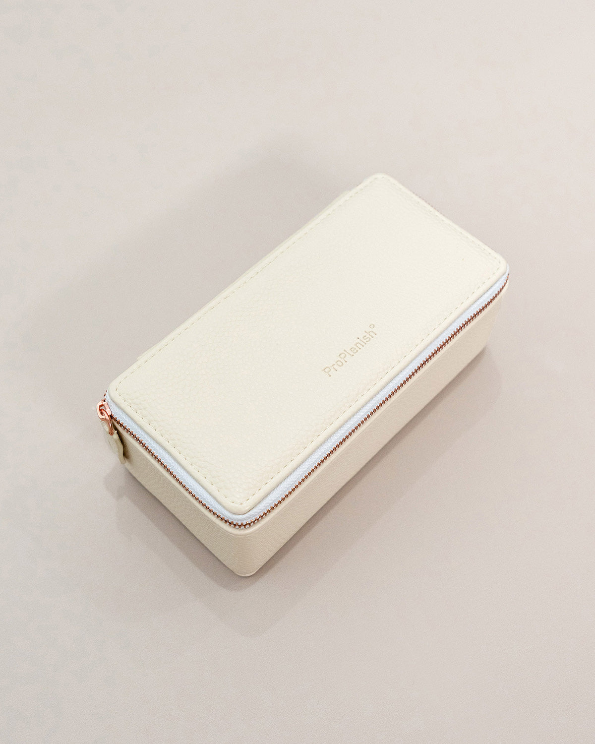 Cream-colored wallet with a zipper on a light gray background